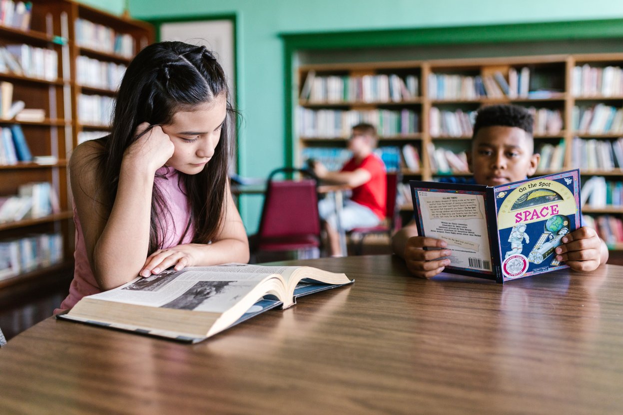 Students Reading Books Inside the Library